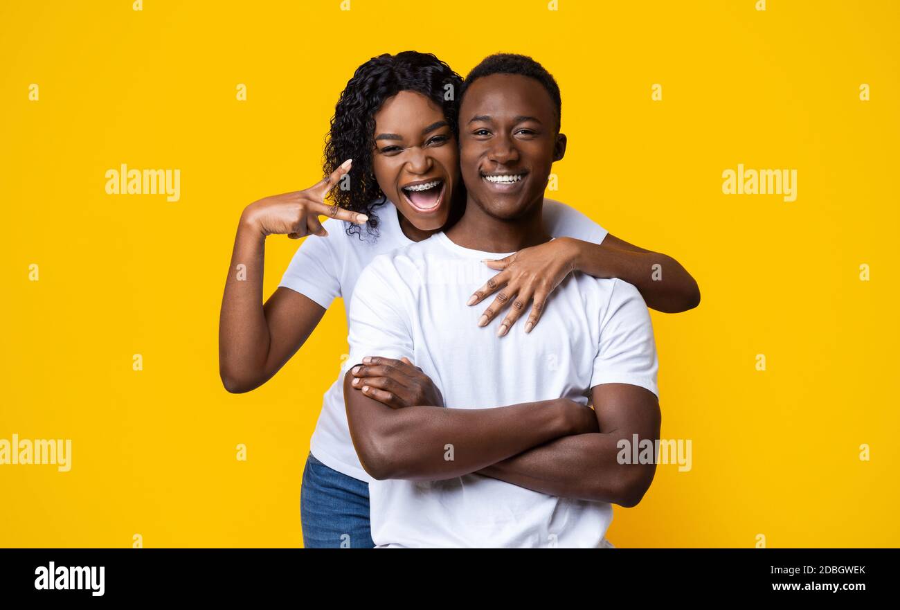 Emotional black woman hugging her smiling boyfriend Stock Photo - Alamy