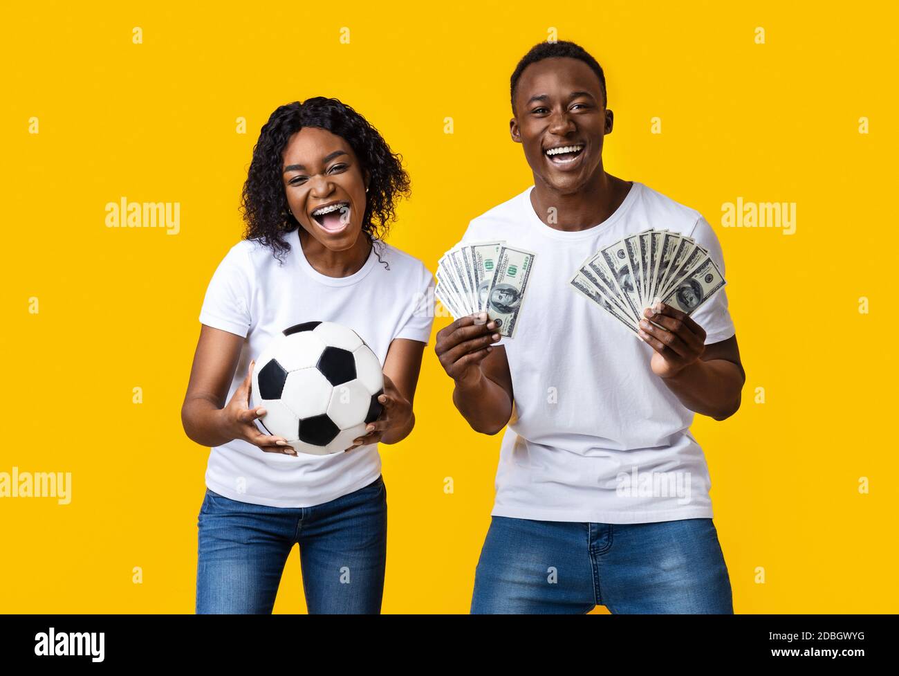 Excited african-american couple enjoying sport bet win Stock Photo - Alamy