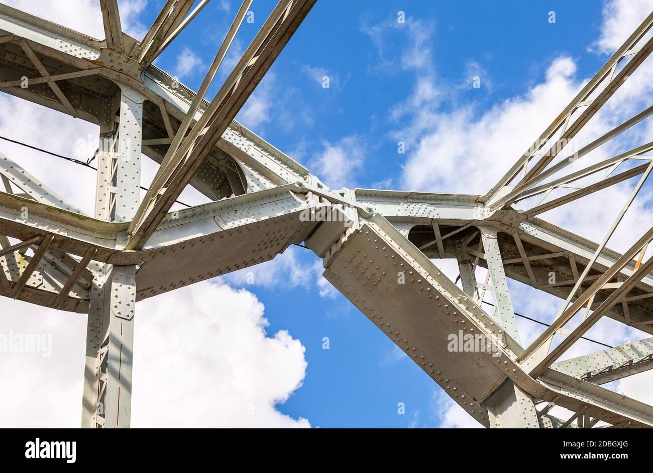 Connecting the spans of the old arched metal bridge. Fastening on steel