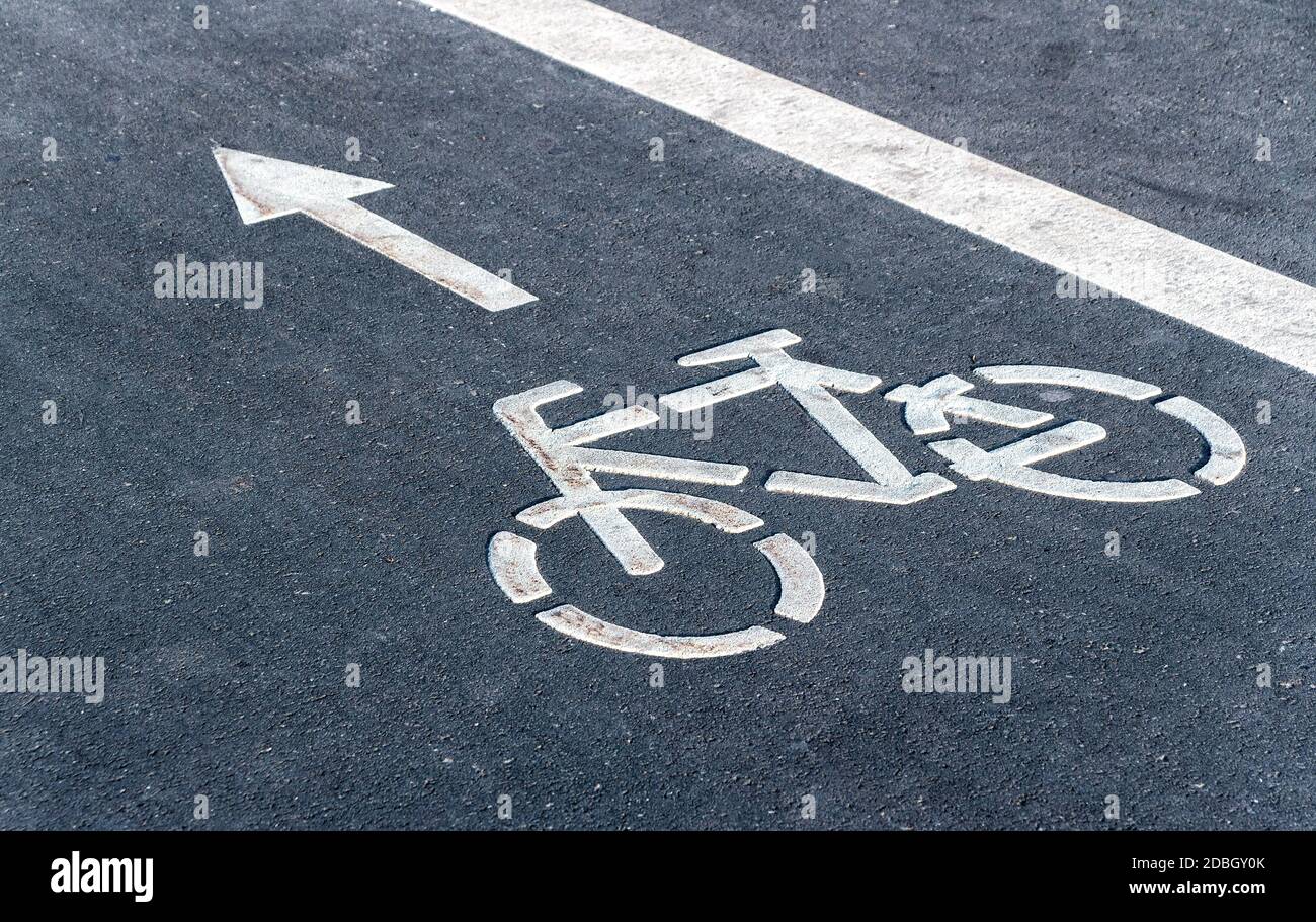 Bicycle symbol on a bike lane with directional arrow of movement