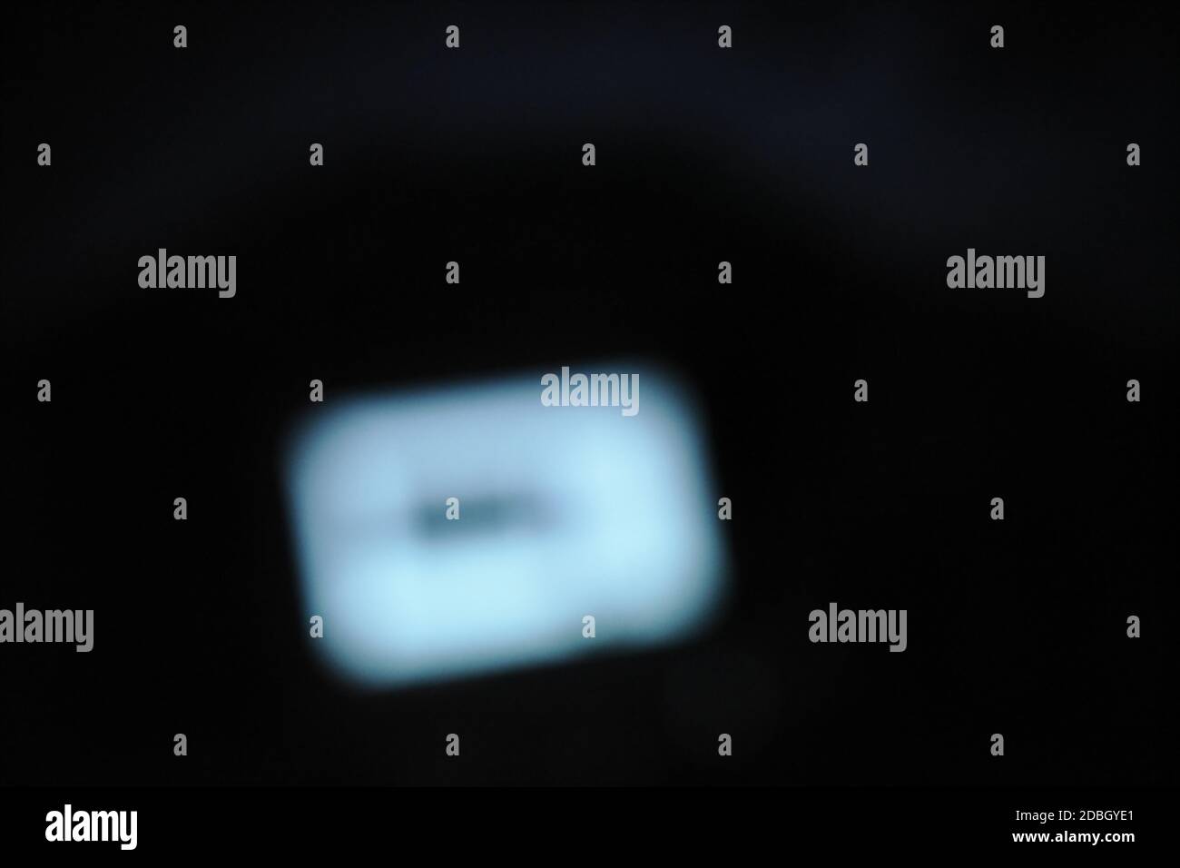 blurry computer screen in dark room background Stock Photo