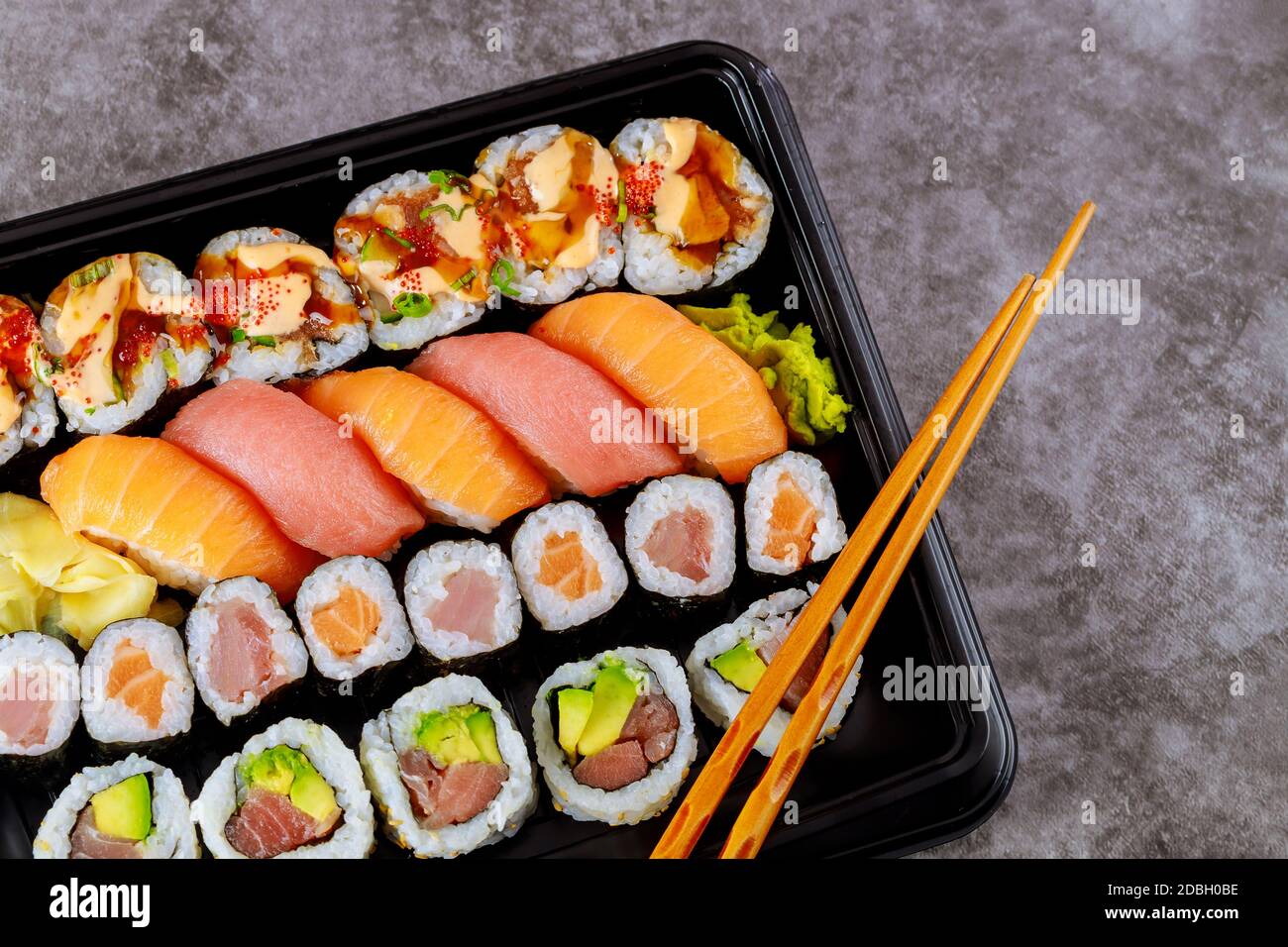 Assortment of sushi roll set on a black tray. Japanese food. Top view. Stock Photo