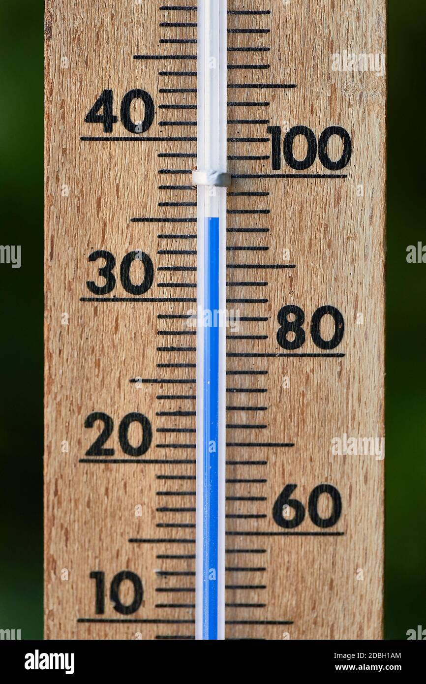 A Celsius thermometer on a window frame shows high temperatures of 35  degrees during an abnormal heat outside close-up., Stock image