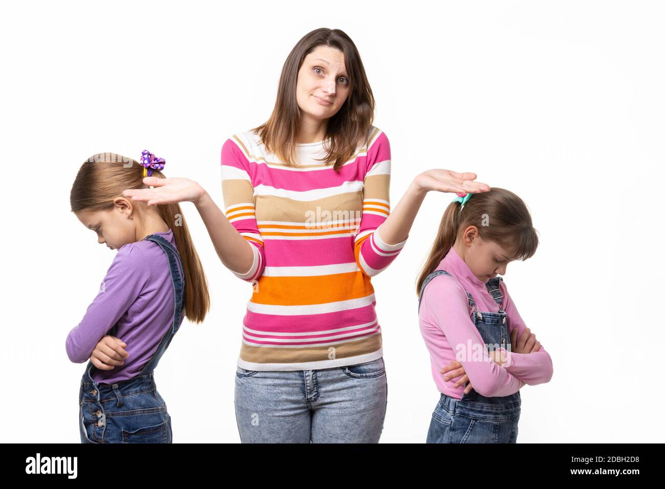 Two girls quarreled, mother does not know how to reconcile Stock Photo