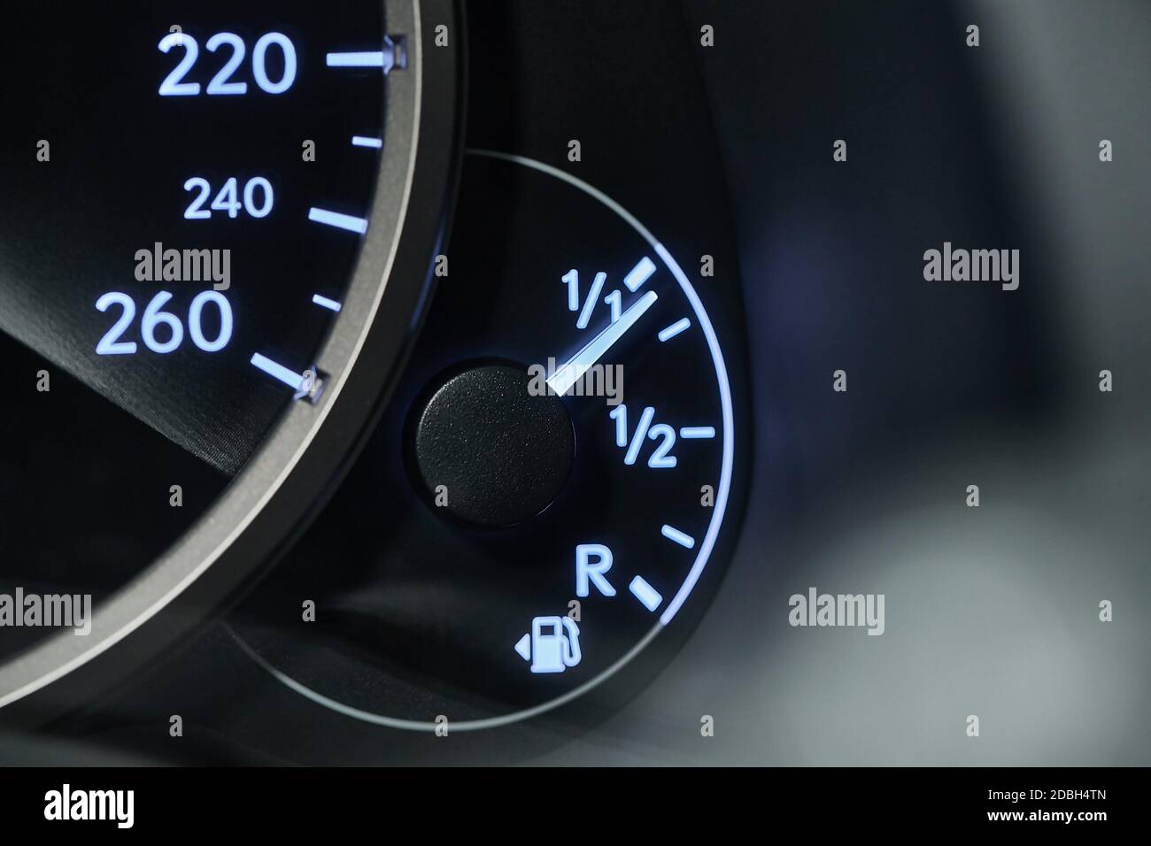 Fuel indicator of a car going down Stock Photo Alamy