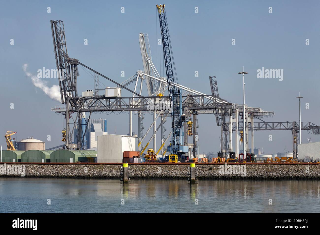Large harbor cranes loading container ships in the port of Rotterdam ...