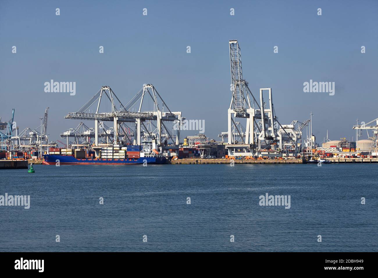 Large harbor cranes loading container ships in the port of Rotterdam ...