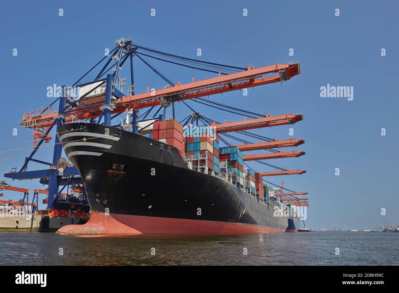 Large harbor cranes loading container ships in the port of Rotterdam ...