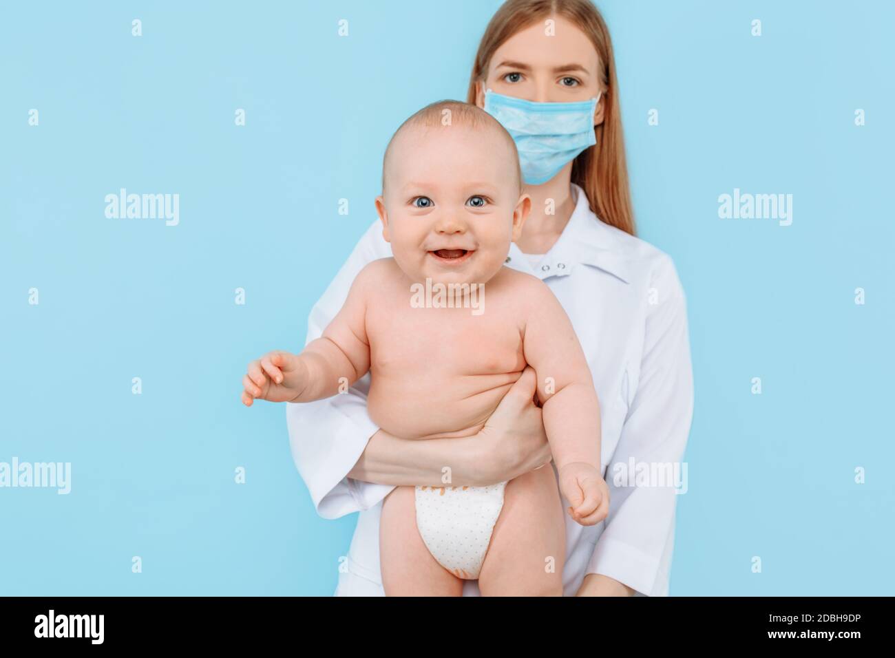 The concept of medicine , healthcare and Pediatrics- a female pediatrician with a digital infrared thermometer that measures the baby's body temperatu Stock Photo