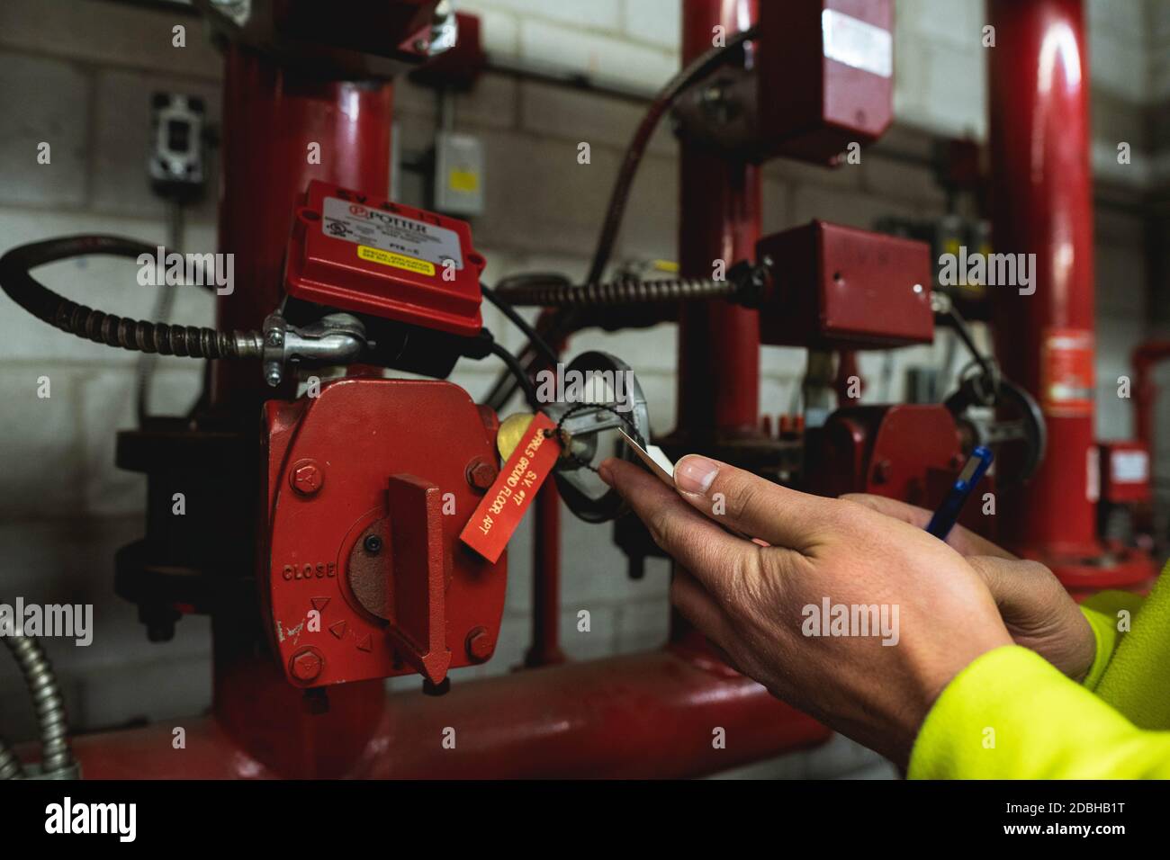 Unrecognizable Technician hand inspecting sprinkler system card Stock Photo