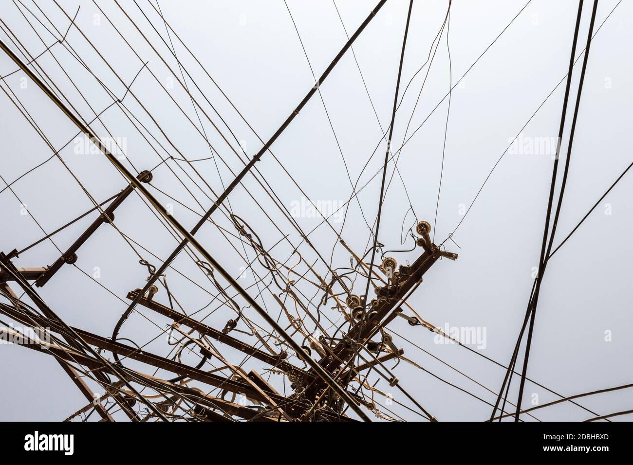 Messy electrical wires isolated on greyblue background Stock Photo
