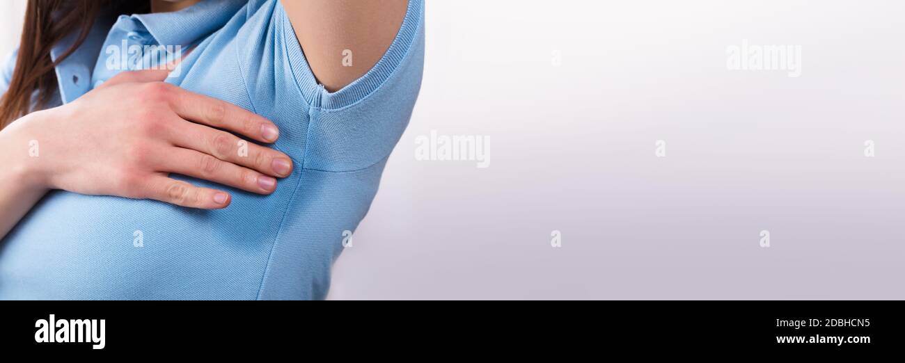 Woman sweating badly under armpit hires stock photography and images