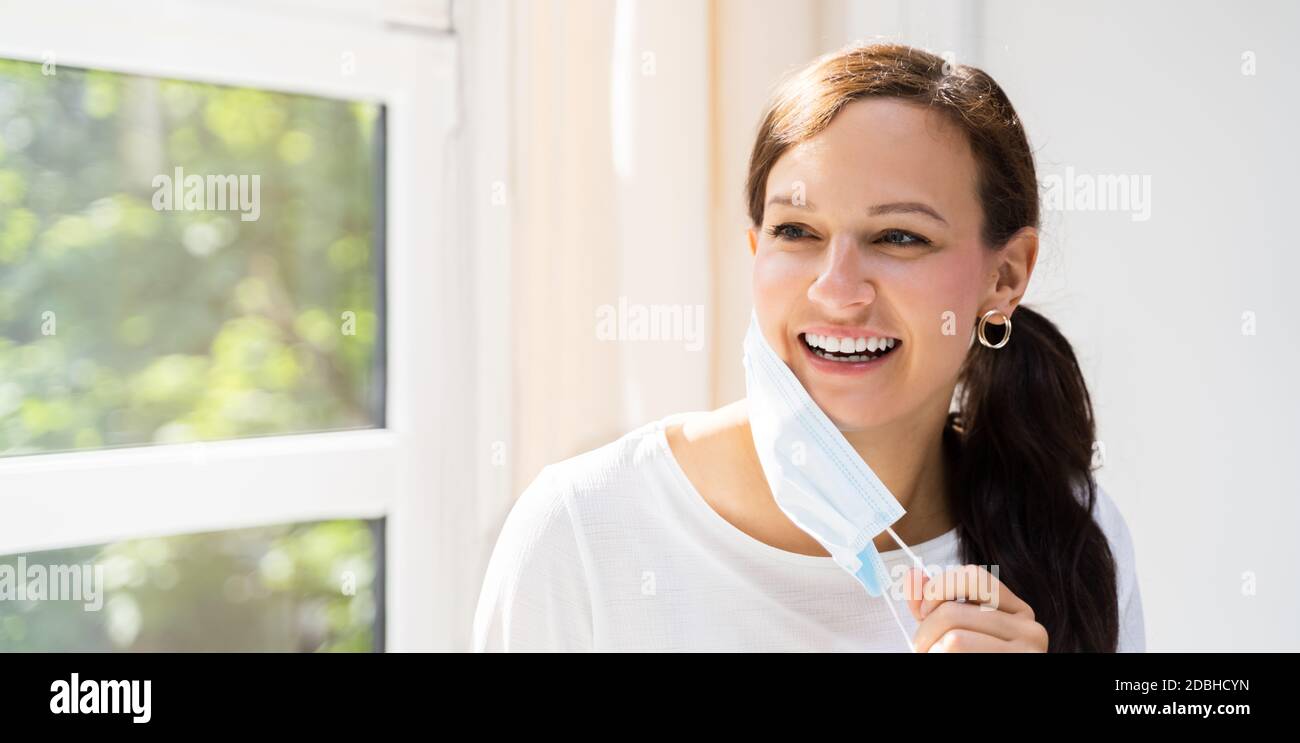 Woman removing covid mask hi-res stock photography and images - Alamy