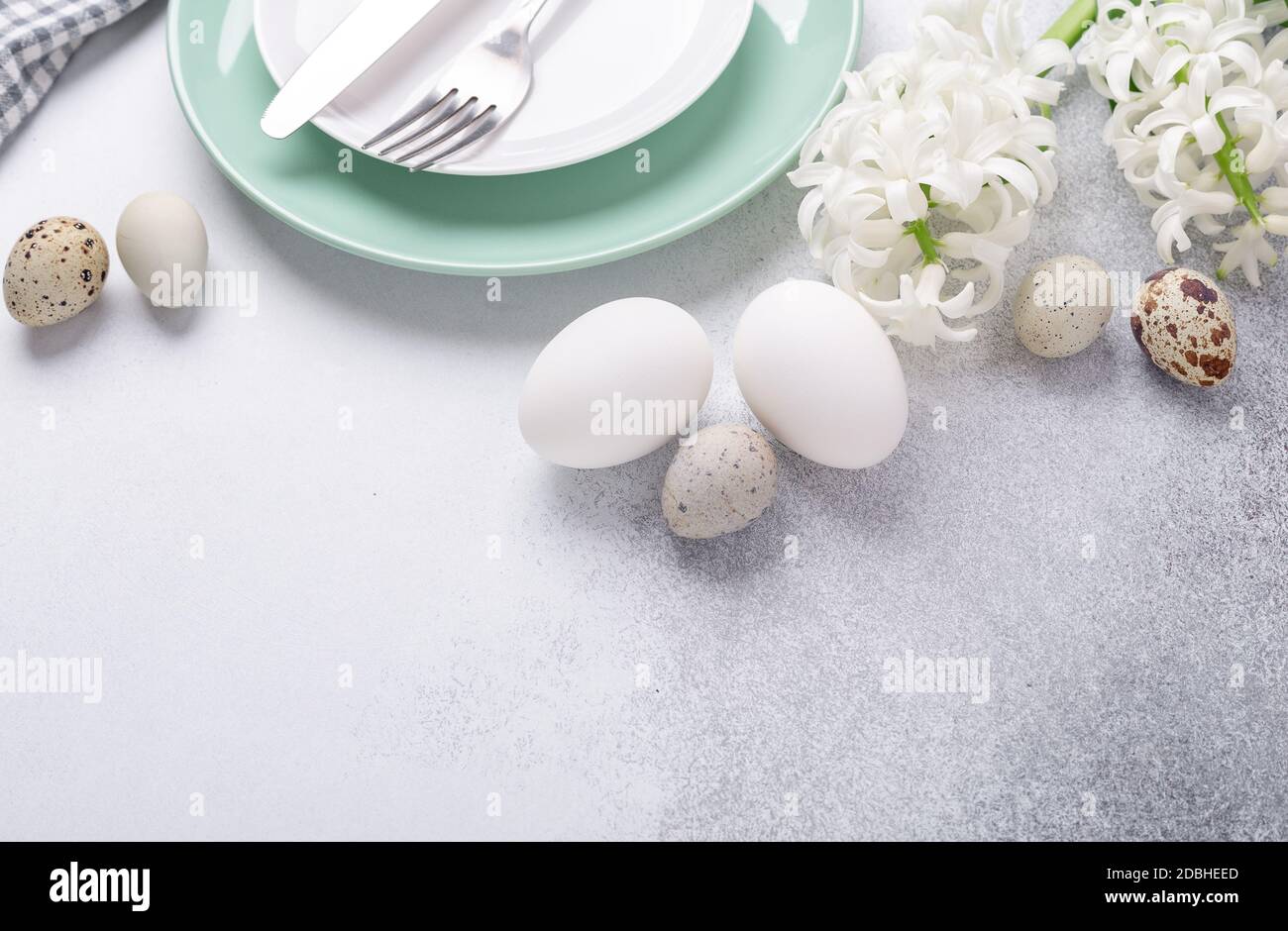 Light Easter composition. Green mint plate, easter eggs, pink and white hyacinth on stone background. Easter concept - Image Stock Photo