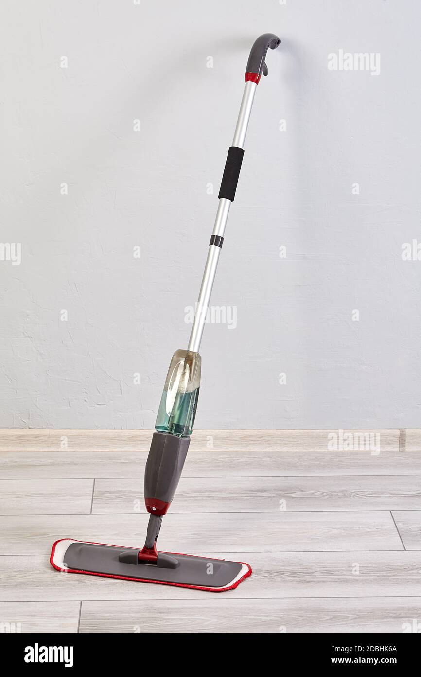 Spraying flat mop with microfiber head is used for wet mopping Stock Photo  - Alamy