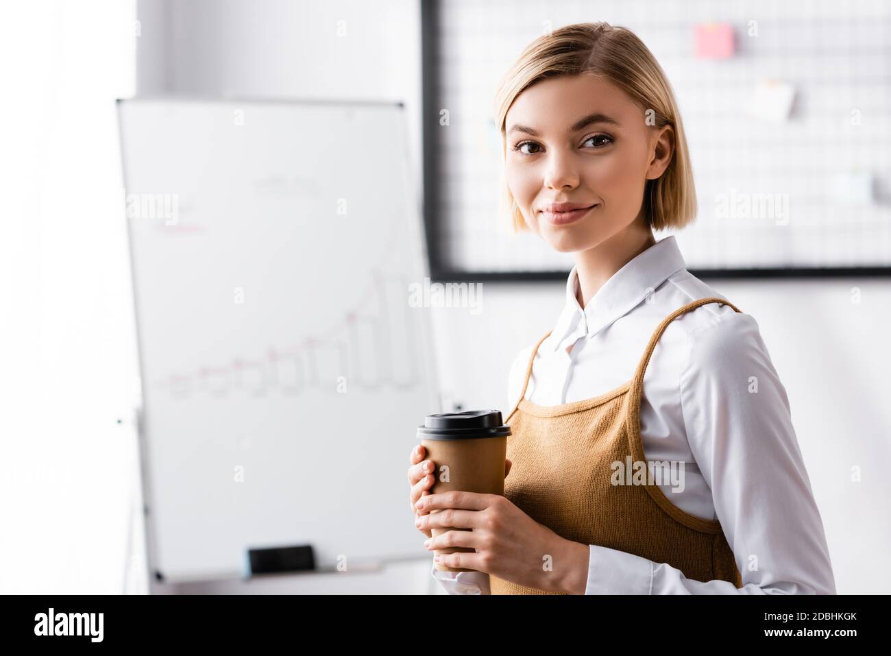 happy businesswoman looking at camera while holding coffee to go Stock ...