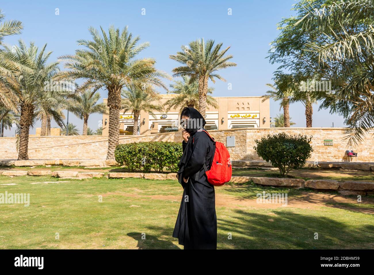 A woman wearing black hijab visiting the ruins of Diraiyah, also as Dereyeh and Dariyya, a town in Riyadh, Saudi Arabia Stock Photo