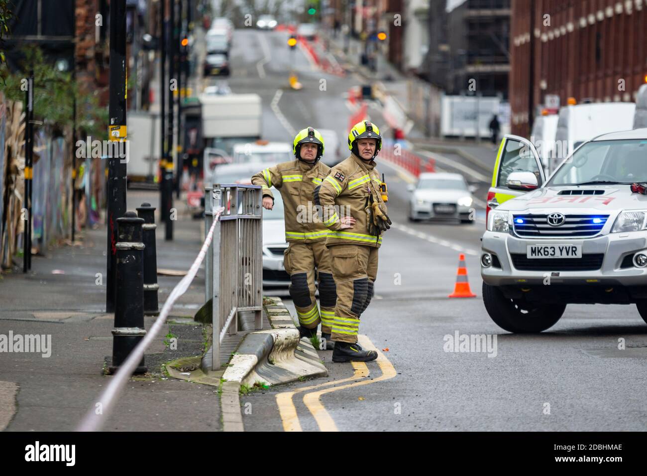A couple of firefighters from West Midlands Fire Service at an incident in Digbeth, Birmingham. Stock Photo