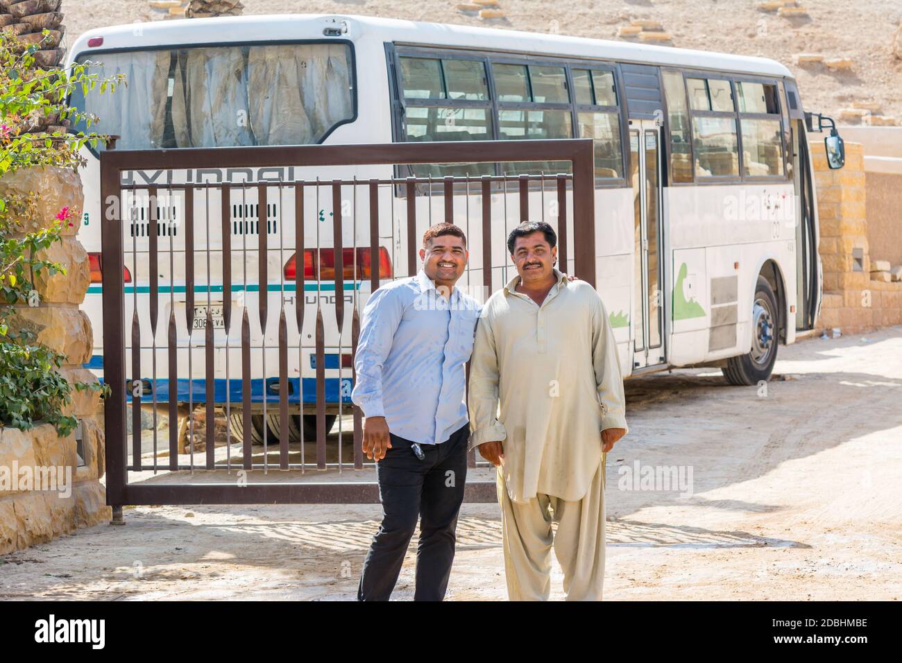 Pakistani security guard wearing traditional clothes and standing in