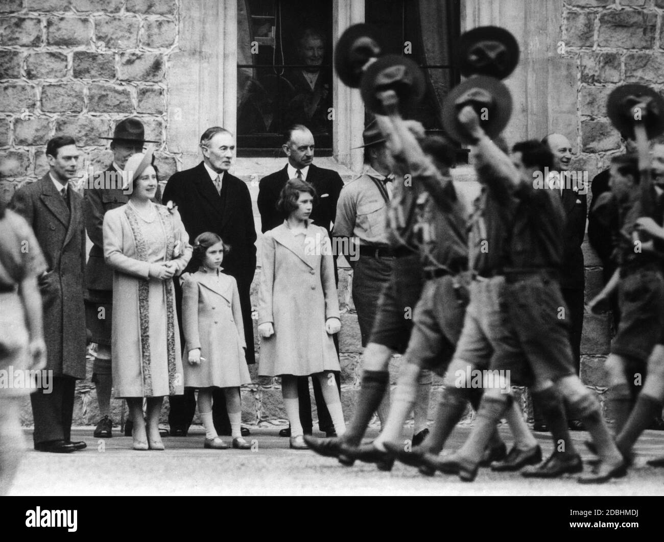 More than 1000 scout boys walk past the royal family and greet them. From left to right: King George VI, Queen Elizabeth, Princess Elizabeth, Princess Margaret Rose and the Archbishop of Canterburry. Stock Photo