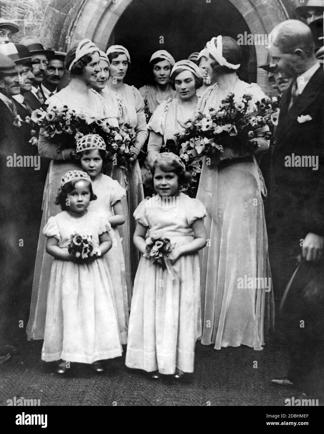 Elizabeth II (front right) as one of the flower girls before the bridesmaids at the wedding of Lady May Cambridge and Henry Abel Smith the church in Balcome, Sussex. Stock Photo