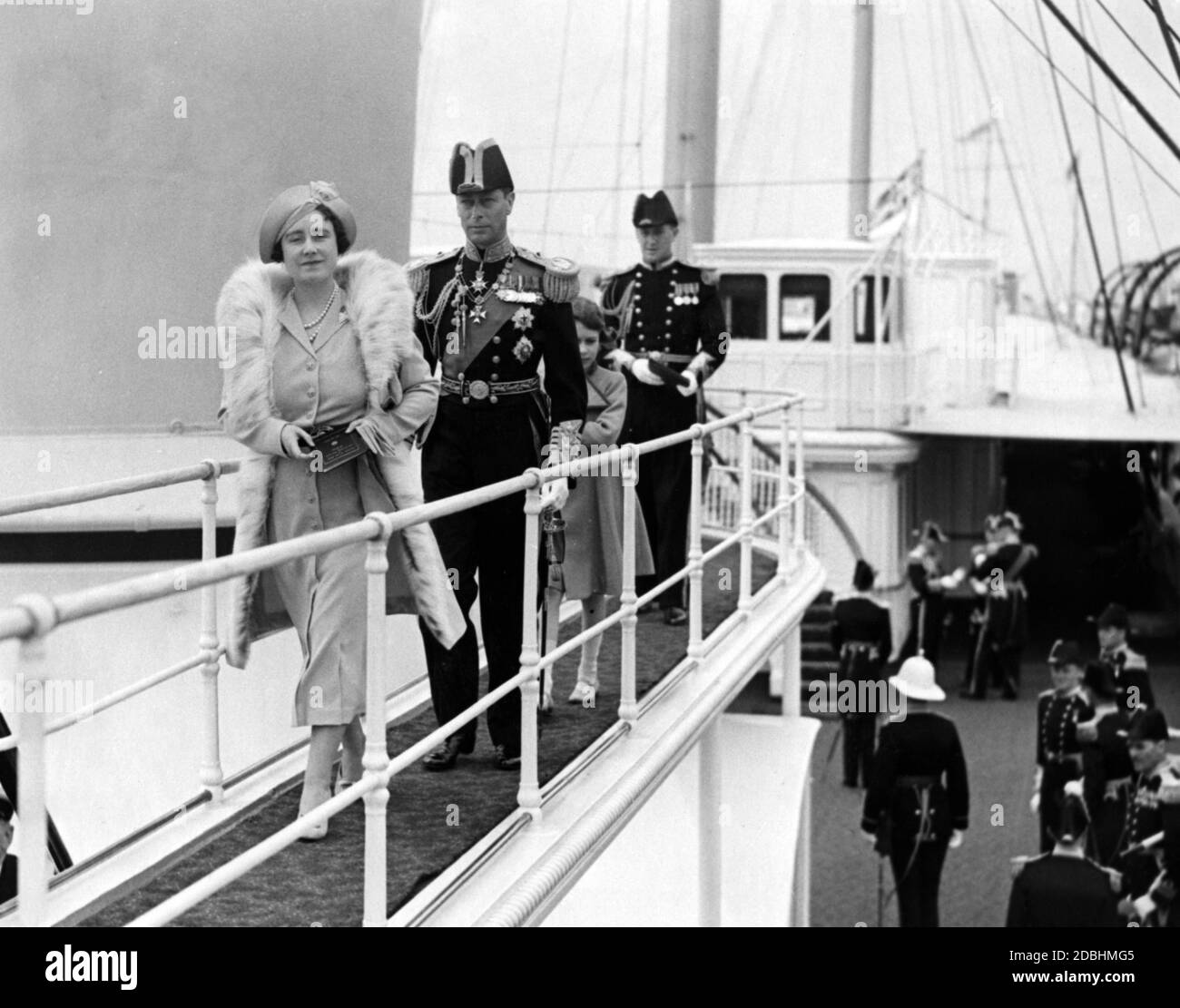 'Queen Elizabeth, King George VI and Princess Elizabeth on the way to the bridge of the royal yacht ''Victoria and Albert'' during the ''Naval Review''. ' Stock Photo