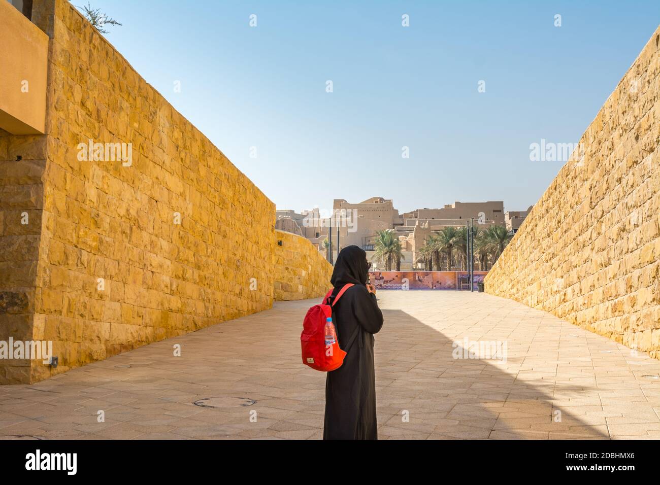A woman wearing black hijab watching ruins of Diraiyah, also as Dereyeh and Dariyya, a town in Riyadh, Saudi Arabia Stock Photo
