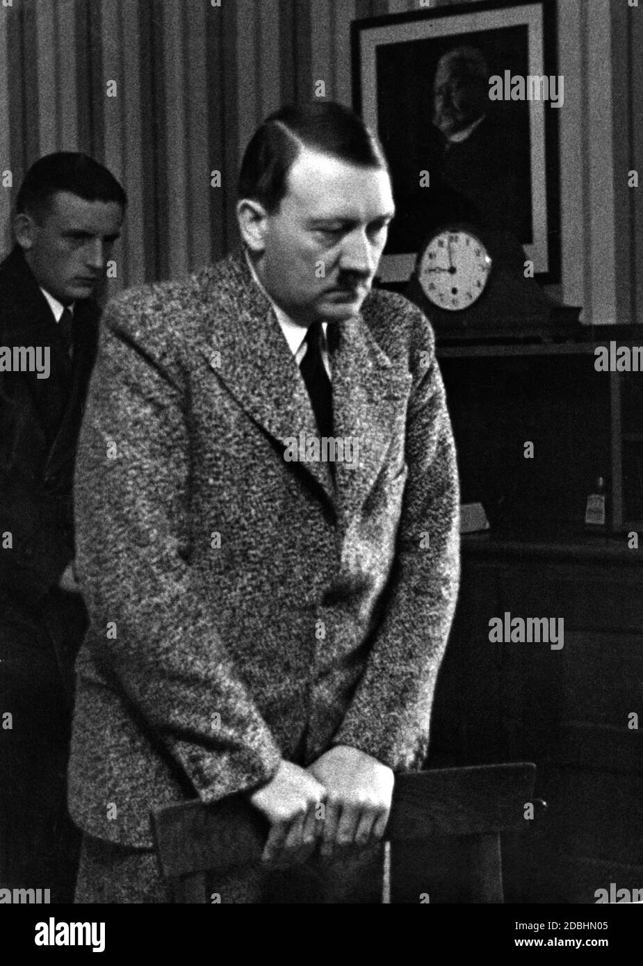 Hitler listens to the results of the 1935 Saar elections on the radio. In the background hangs a picture of former Reich President Paul von Hindenburg. Stock Photo