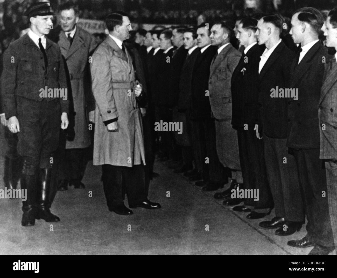 Adolf Hitler and Graf von Helldorf, the future Chief of Police of Berlin, are inspecting a formation of the SA Berlin-Brandenburg in the Sportpalast. Between the two, Wilhelm Brueckner. Stock Photo