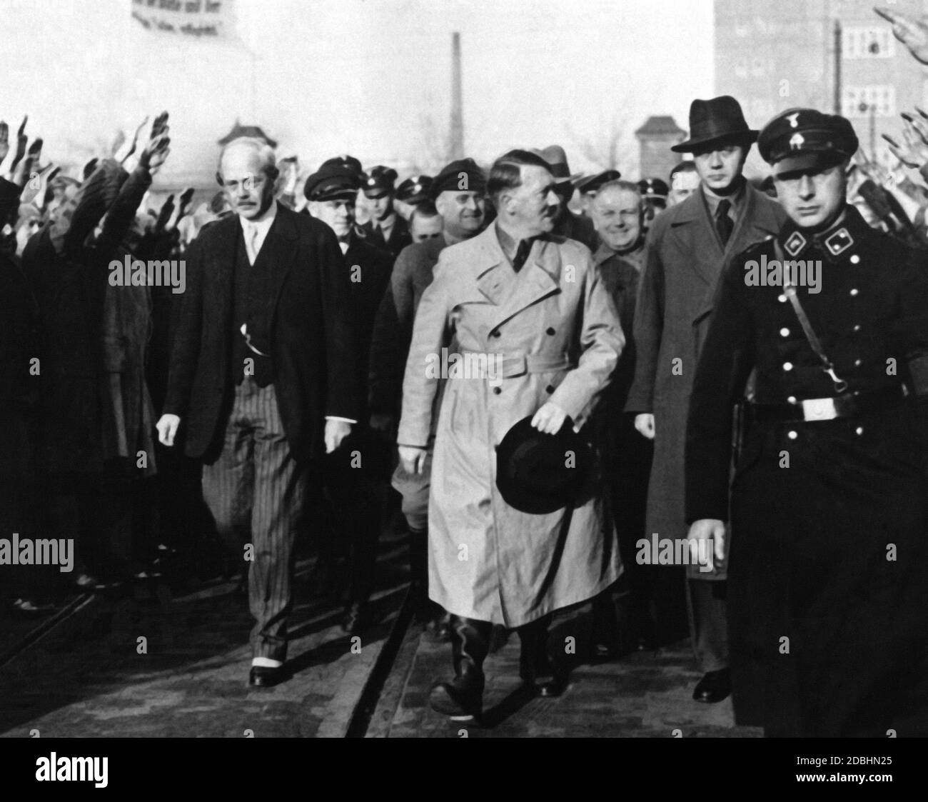 At a works meeting of Siemens Werke in Berlin, Carl Friedrich von Siemens and Adolf Hitler are accompanied by other Siemens employees and members of the SS. Stock Photo