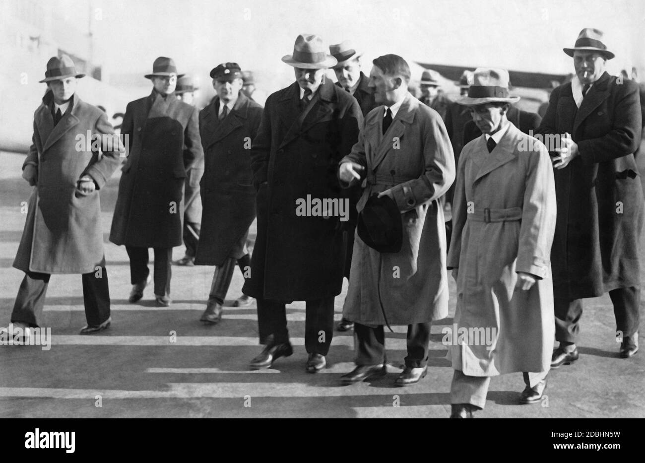 Adolf Hitler is greeted by Paul von Hindenburg at the Tempelhofer Feld in Berlin. Next to Hitler are Dr. Joseph Goebbels and, at the back right, Hitler's chief adjutant Wilhelm Brueckner. At that time Hitler always carried a dog whip with him as an accessory. Stock Photo