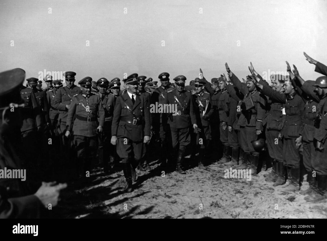 Adolf Hitler visits troops before they cross the Vistula. He is accompanied by Martin Bormann (left behind Hitler) and Reinhard Heydrich (right behind Hitler). Stock Photo