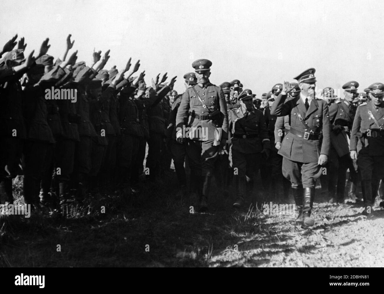 Adolf Hitler visits troops before they cross the Vistula. He is accompanied by Martin Bormann (left behind Hitler) and Reinhard Heydrich (right behind Hitler). Stock Photo