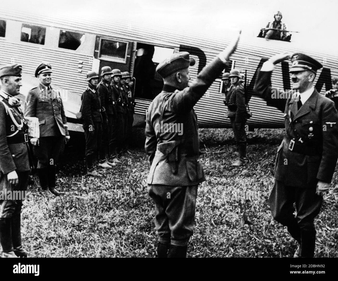 Adolf Hitler is welcomed in Poland by Walter von Reichenau at a frontline airstrip. In the background, Hitler's Wehrmacht adjutant Engel and the pilot of the Fuehrer's aircraft, Hans Baur, together with soldiers of the Luftwaffe. Stock Photo
