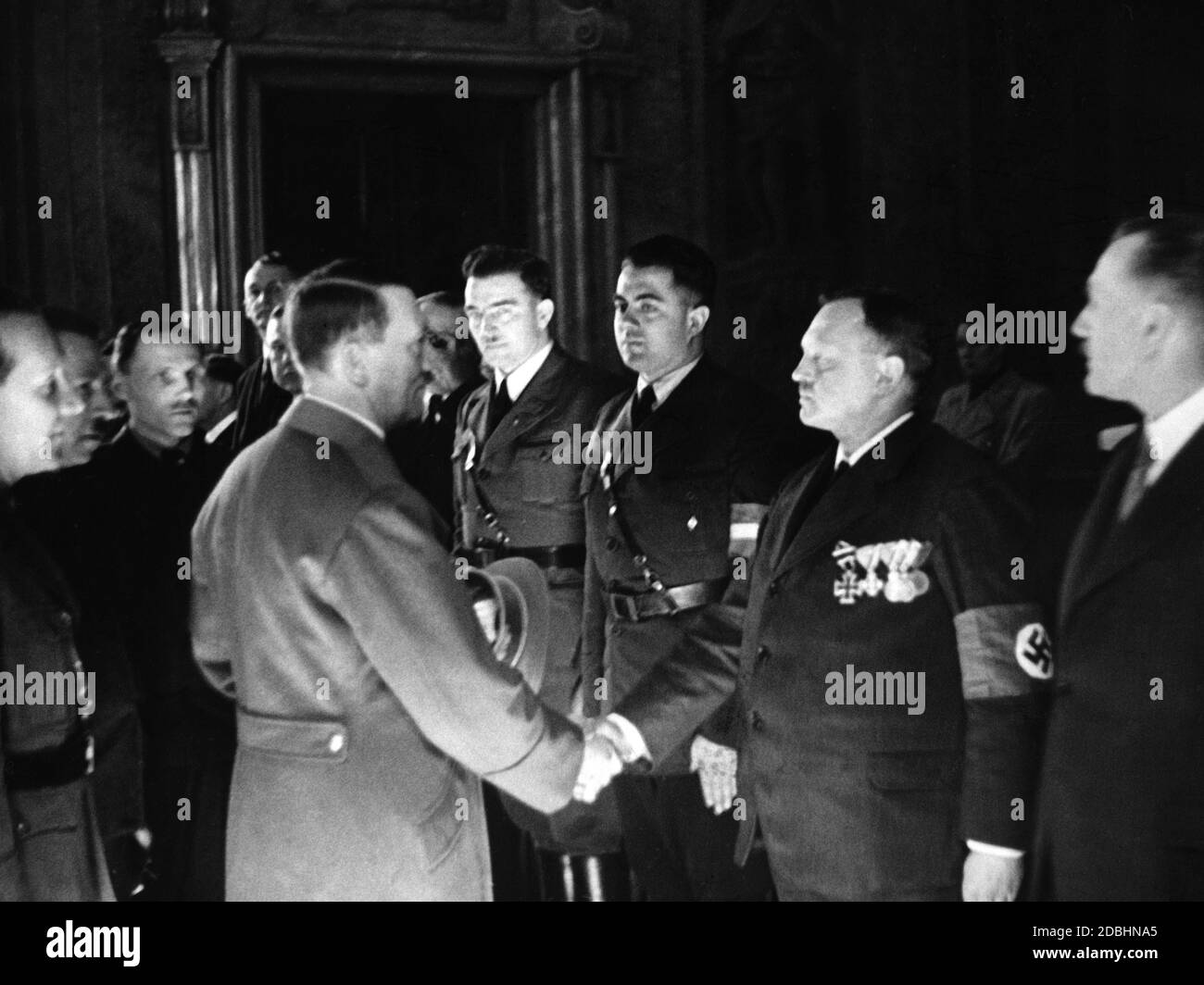 Adolf Hitler during the invasion in the so-called Rest of the Czech Republic in Bruenn while greeting Alter Kaempfer (old fighters) of the National Socialist movement. Stock Photo