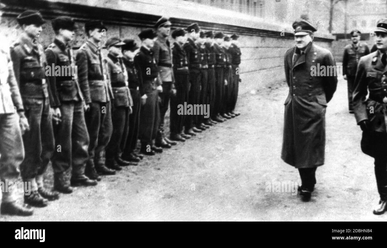 Adolf Hitler with children and adolescents of the Hitler Youth, who were sent to the slaughter in the last weeks of the war against the Red Army. Next to Hitler, the Reich Youth Leader Arthur Axmann at an inspection. Stock Photo