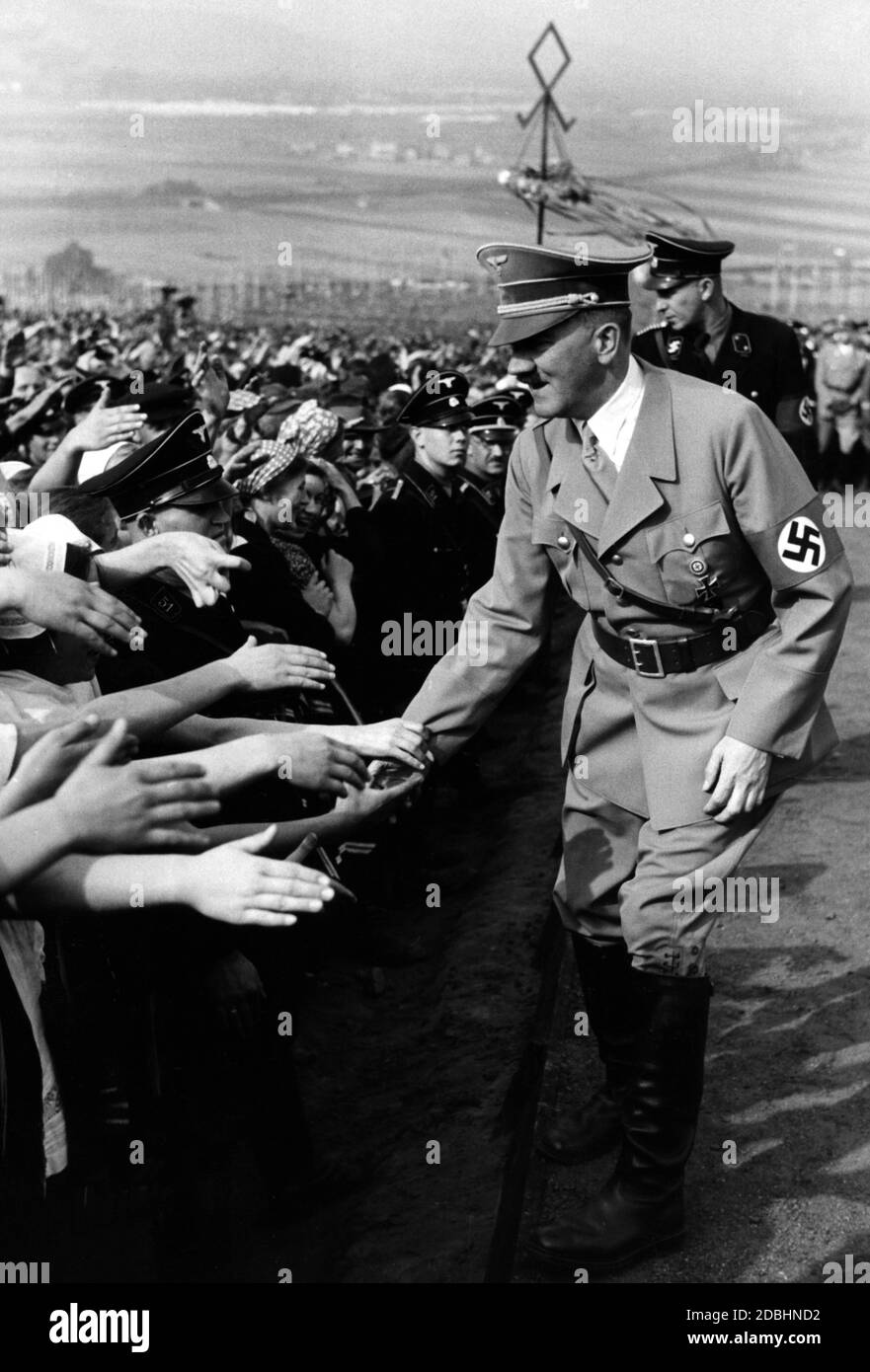 Adolf Hitler shaking hands on the way to the rostrum on the Bueckeberg. Stock Photo