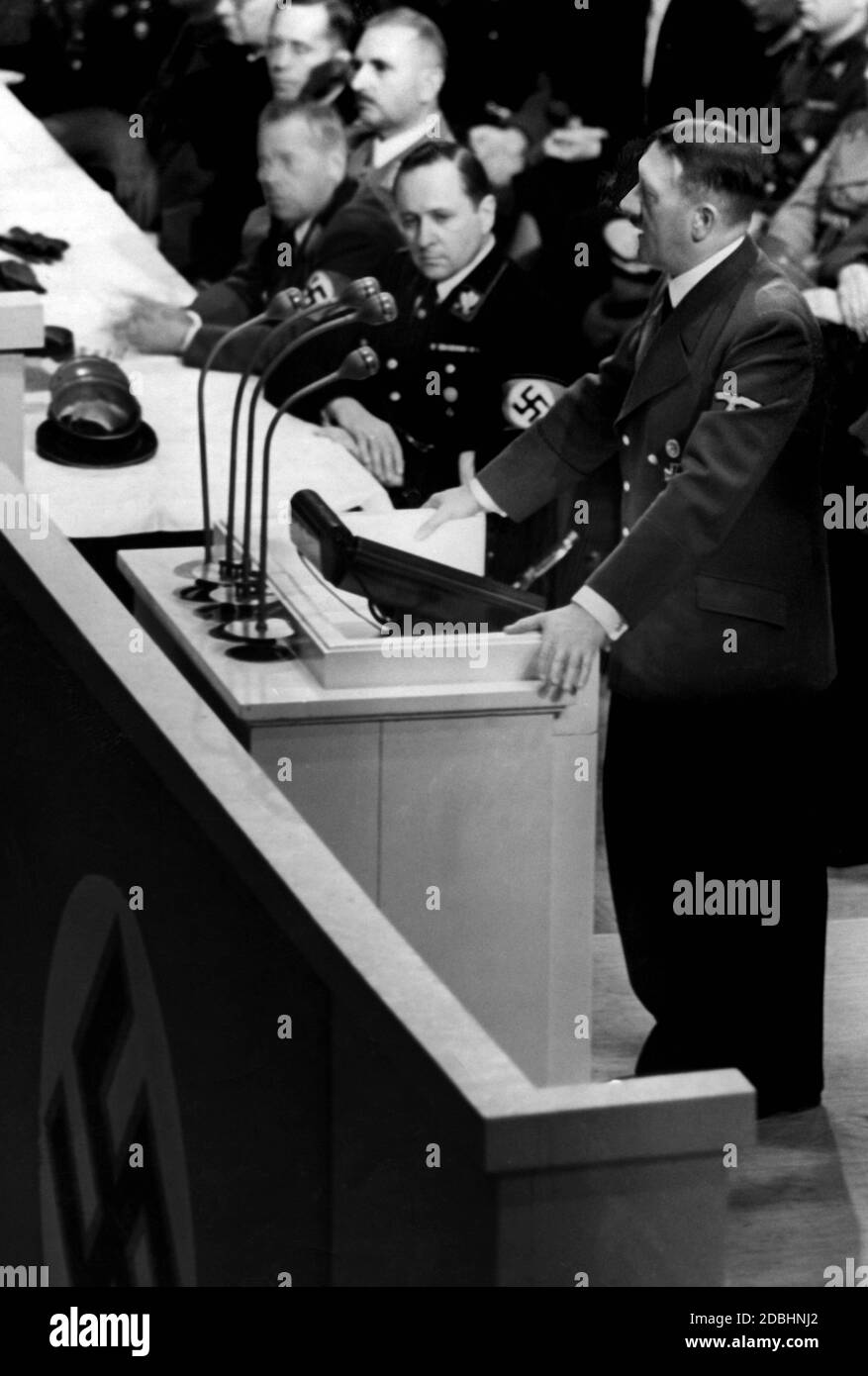 Adolf Hitler opens the 1939 Winterhilfswerk with his speech. Next to him, the SS Gruppenfuehrer is probably Himmler's adjutant from Alversleben. Stock Photo