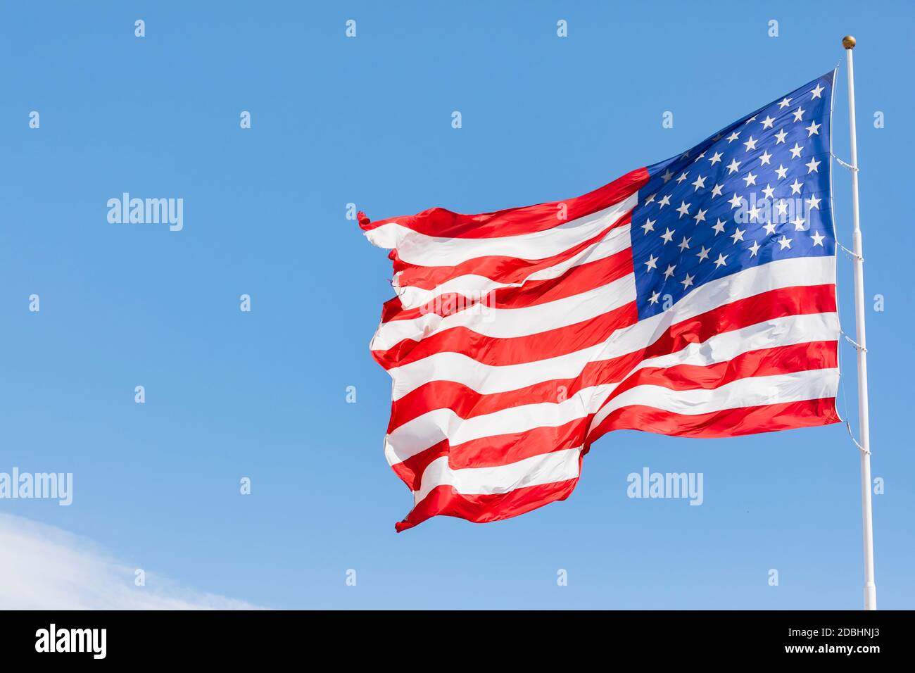 American flag waving in the wind, US flag motion on blue sky, United States of America national flag. USA stars and stripes Stock Photo