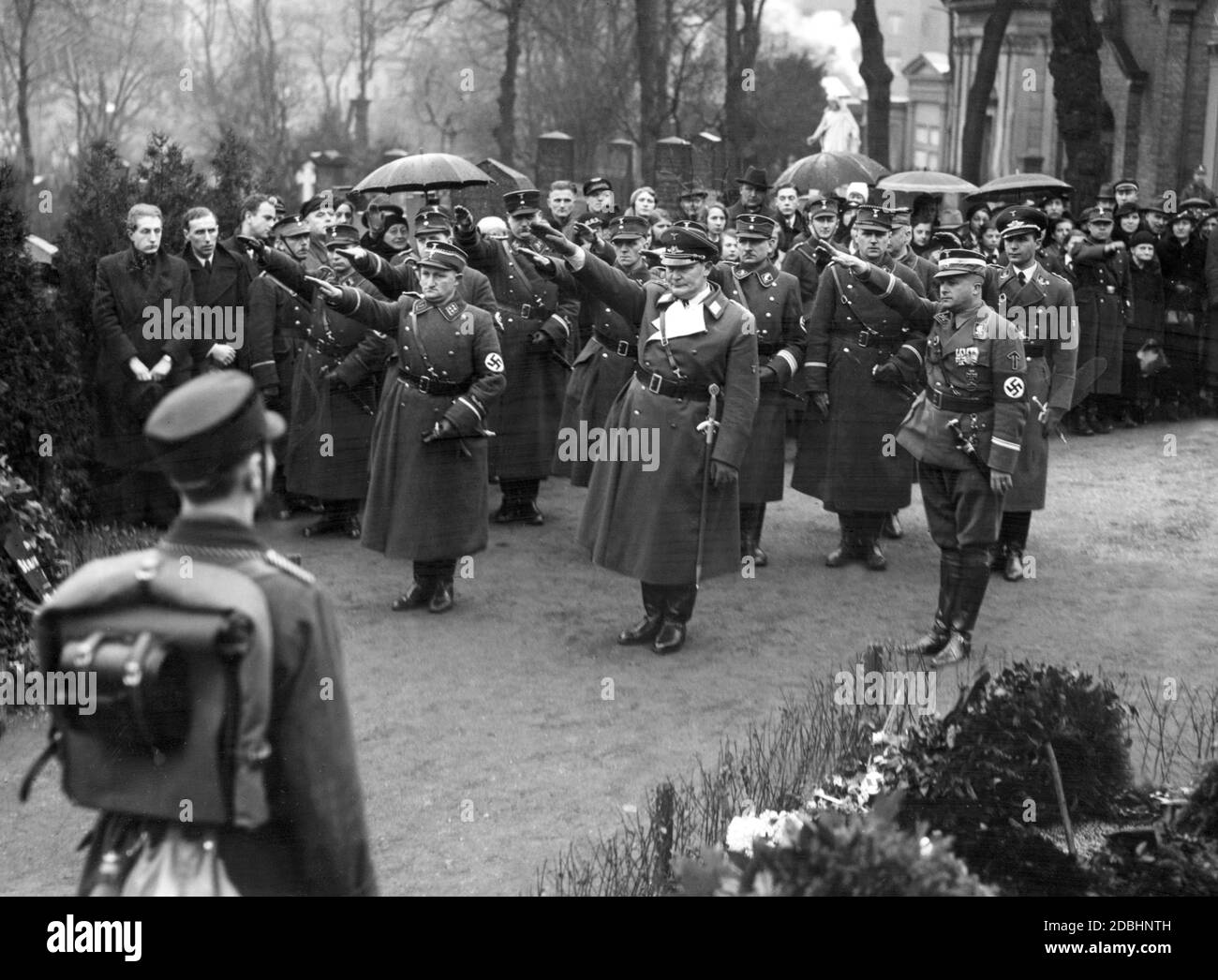 Hermann Goering commemorates the SA member Horst Wessel, stylized as a martyr of National Socialism, with the Nazi salute. Wessel was buried at the St. Nicholas and St. Mary Cemetery in Prenzlauer Berg. The picture shows on the right side of Goering the SA-Obergruppenfuehrer Dietrich von Jagow, on the left side the Obersturmbannfuehrer Fritz Schlageter. Stock Photo