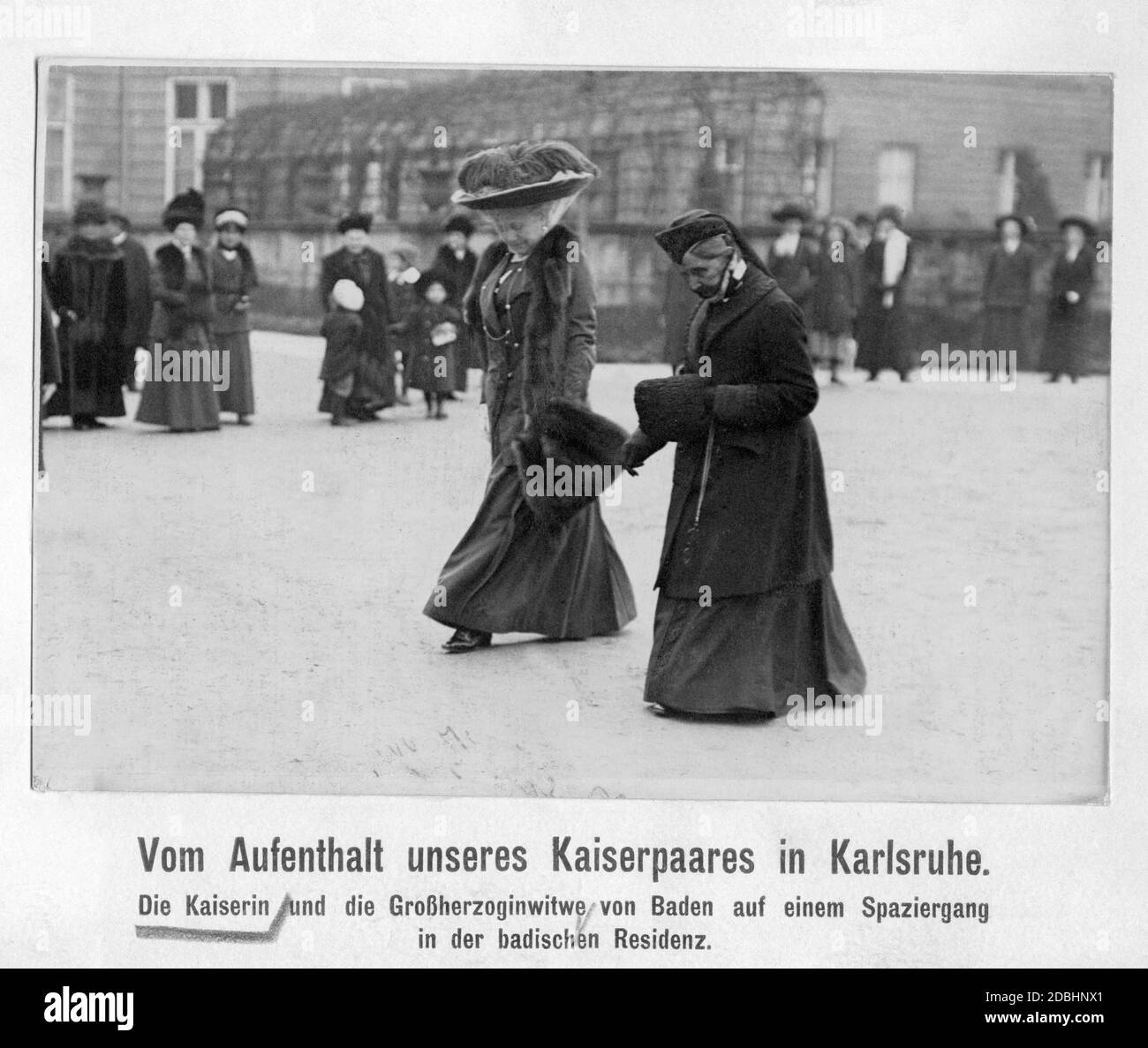 Empress Augusta Victoria (center) is on a walk with widow Grand Duchess Louise of Baden (nee Prussia) through the Baden residence.  The imperial couple had previously traveled to Karlsruhe. Stock Photo