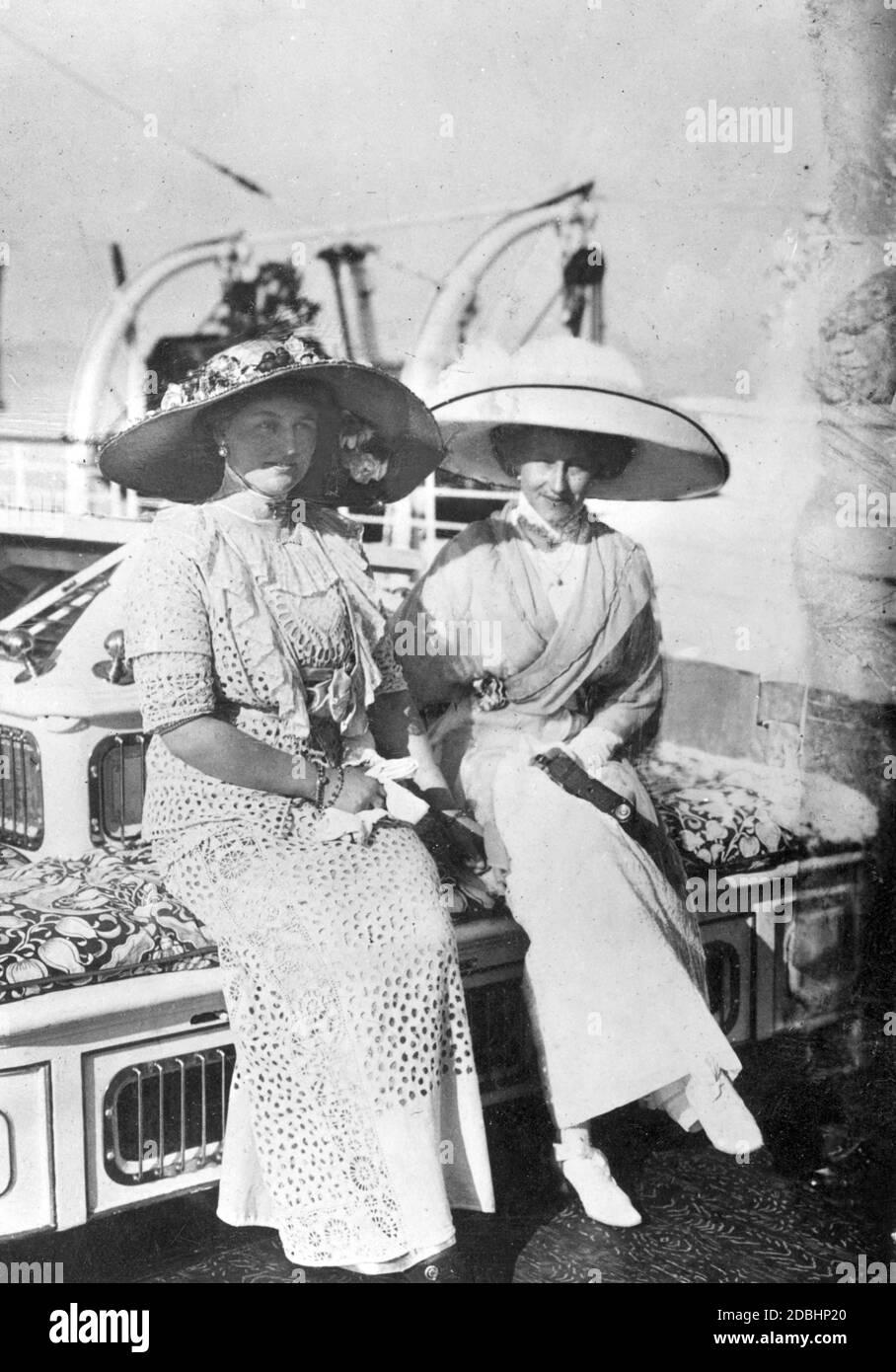 The princesses Alexandra Viktoria of Prussia (left, nee of Schleswig-Holstein-Sonderburg-Gluecksburg) and Victoria Louise of Prussia (right) are sitting on board the S.M.Y. Hohenzollern. They had sailed to Corfu together with the Emperor in 1912. Stock Photo