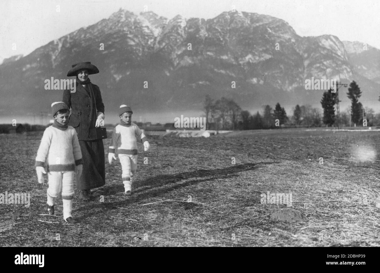 Crown Princess Cecilie of Prussia (born in Mecklenburg) walks together with her eldest sons, Prince Wilhelm (left) and Louis Ferdinand (right) of Prussia, near Partenkirchen in 1912. In the background is the Kramerspitz. Stock Photo