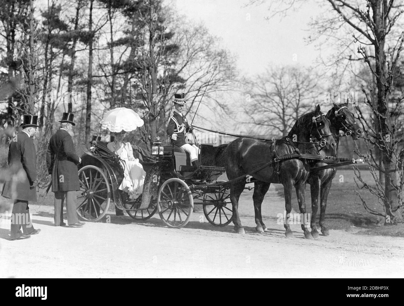 Crown Princess Cecilie of Prussia (born of Mecklenburg) is driven in a carriage through a park near Potsdam. The photo was taken in 1906. Stock Photo