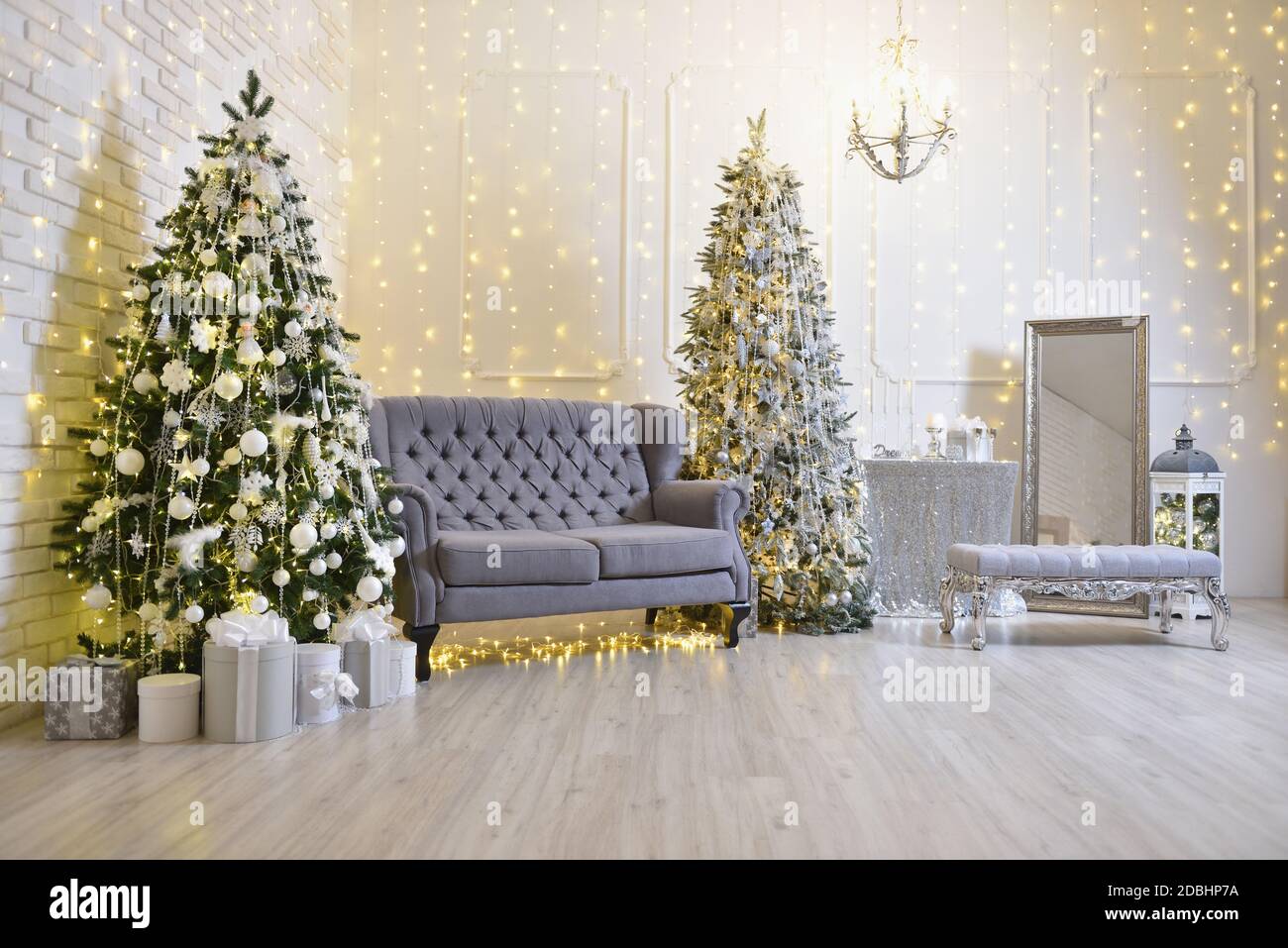 Elegant Christmas decorations in the living room with a gray sofa, two
