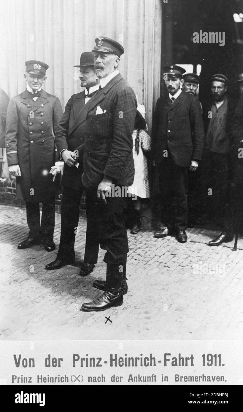 Prince Henry of Prussia (centre, wearing a pinstripe suit) was a prominent guest of the last Prinz-Heinrich-Fahrt (Prince Henry Tour) in 1911, which was sponsored by him. The picture shows him after his arrival in Bremerhaven, after having been in Southampton before. Stock Photo