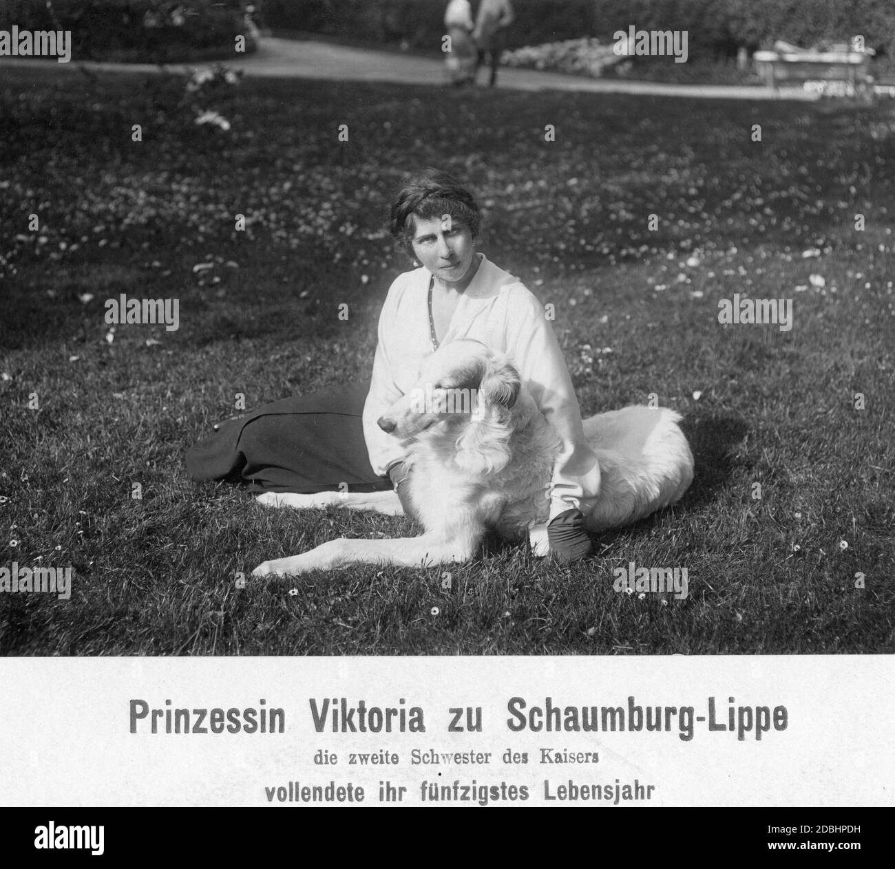 Princess Viktoria of Schaumburg-Lippe (born of Prussia, sister of Wilhelm II) with a dog in a meadow in a park. She became 50 years old on April 12, 1916. Stock Photo