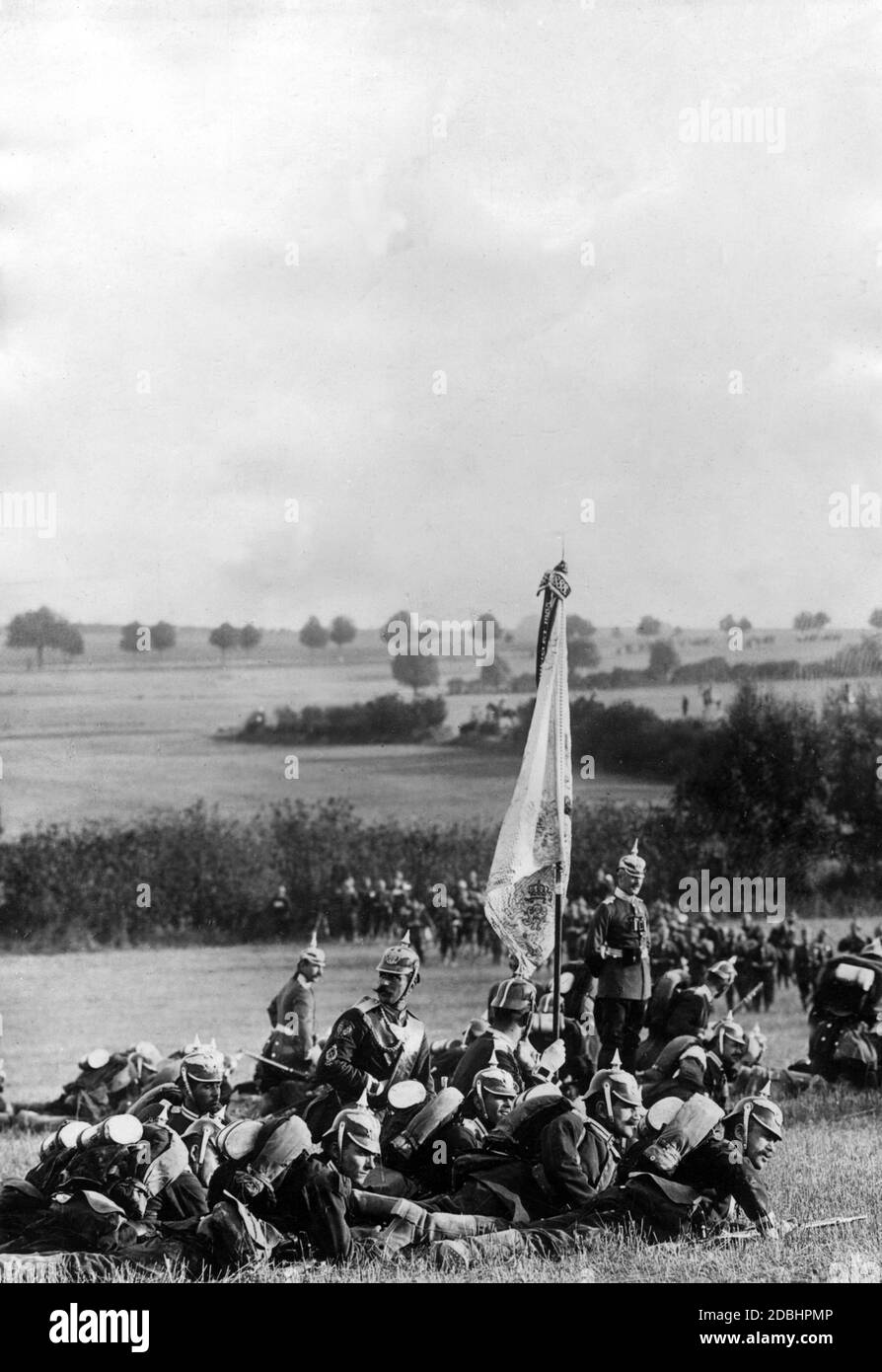 Imperial maneuver in September 1904, during which the flags of the fighting troops are carried along, as they have been done in past centuries. The spiked helmets and spearheads are flashing. Stock Photo