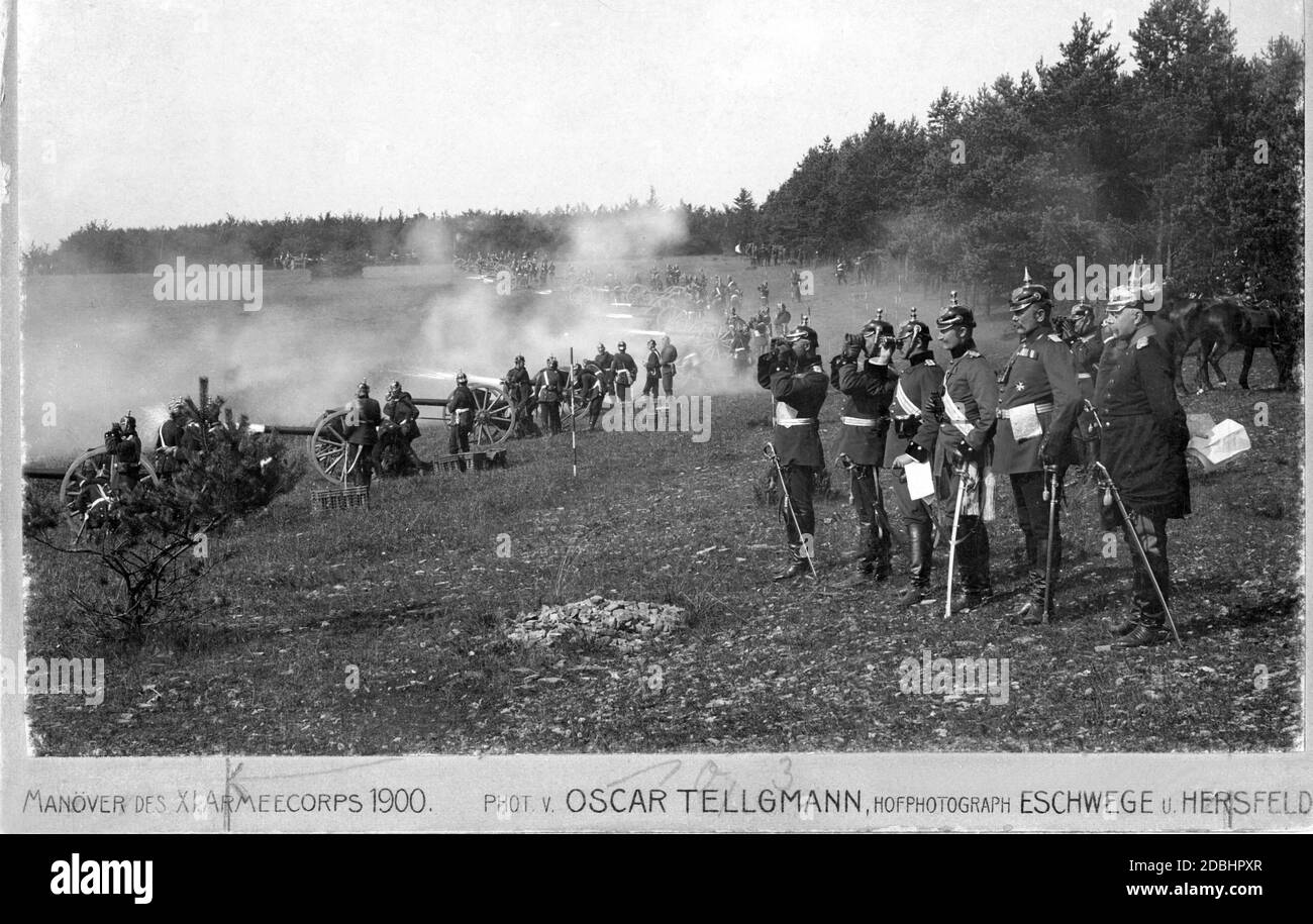 One of the most famous photos of the photo pioneer Oskar Tellgmann, specialist in maneuver photography. It shows soldiers of the Feldartillerie-Regiments 47 firing a salvo in the area near Grandenborn in the district of Eschwege. Stock Photo