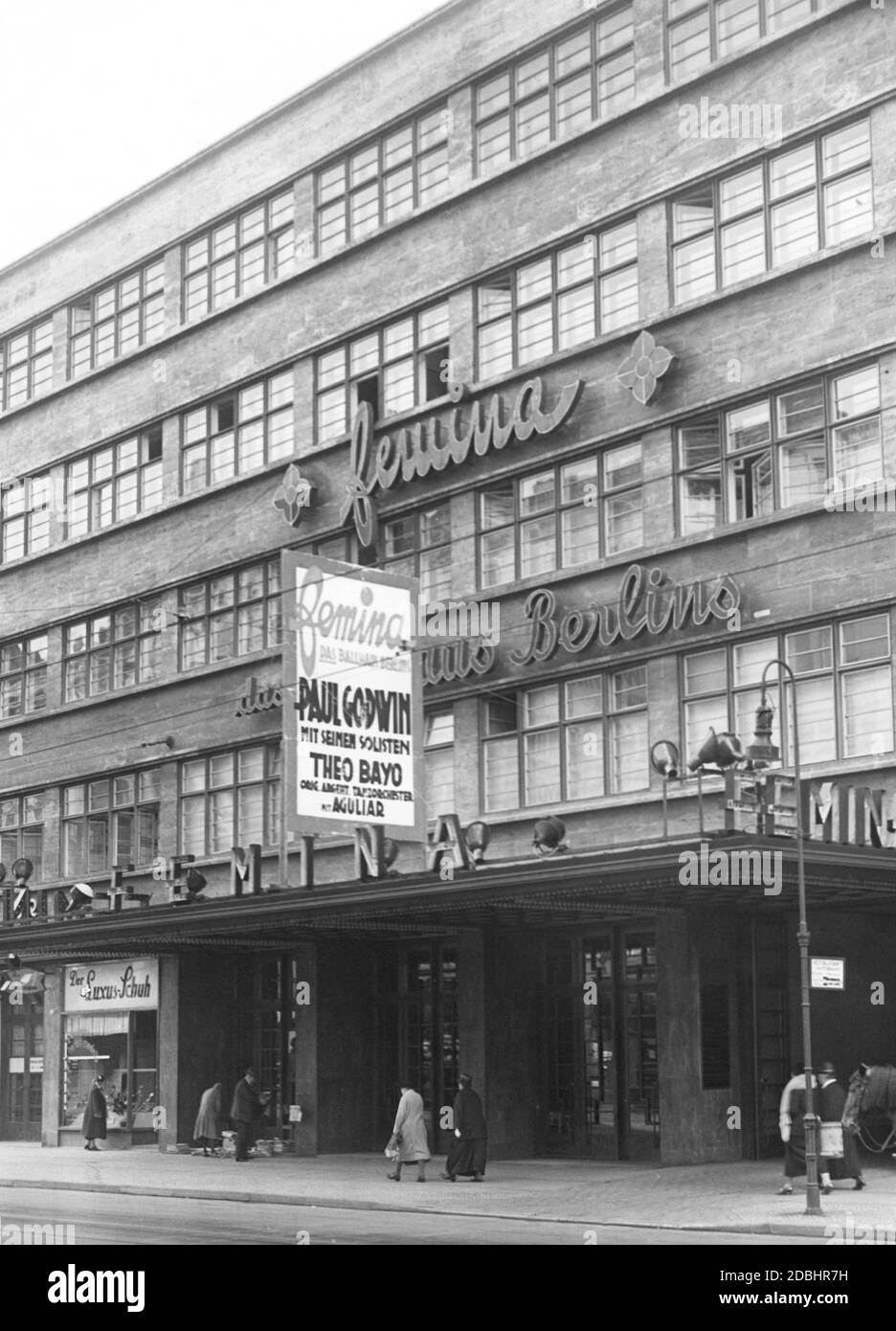 'The Femina-Palast in Nuernberger Strasse 50-56 in Berlin-Schoeneberg in 1932. The building in the New Objectivity (German: Neue Sachlichkeit) style was opened in 1931 and contained offices, a ballroom and numerous entertainment facilities and called itself ''The Ballhouse of Berlin''. At the entrance a woman stands in front of the window of the shoe store ''Der Luxus-Schuh''. A poster advertises: ''Femina / The Ballhouse of Berlin / Paul Godwin / with his soloists / Theo Bayo ...''.' Stock Photo